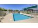 Community pool surrounded by lounge seating, secure fencing, and clear blue sky at 3930 University Center Dr # 311, Las Vegas, NV 89119