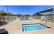 Community pool with hot tub, lounge chairs, and secure fencing for resident relaxation and recreation at 3930 University Center Dr # 311, Las Vegas, NV 89119