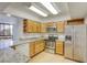 Updated kitchen featuring stainless steel appliances, granite countertops, and wood cabinets at 3930 University Center Dr # 312, Las Vegas, NV 89119