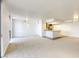 Bright living room and kitchen area with hardwood and carpeted floors and large windows for natural light at 3930 University Center Dr # 312, Las Vegas, NV 89119