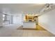 Bright living room and kitchen combo with carpet, hardwood floors, a breakfast bar, and natural light at 3930 University Center Dr # 312, Las Vegas, NV 89119