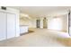 Open living room and kitchen with carpet and wood flooring, large windows, and ample natural light at 3930 University Center Dr # 312, Las Vegas, NV 89119