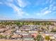 Wide aerial shot shows a vibrant neighborhood with houses, trees, and a mountain range in the distance at 4417 Saint Andrews Cir, Las Vegas, NV 89107