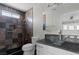 Modern bathroom featuring slate tile, glass sink, and shower at 4417 Saint Andrews Cir, Las Vegas, NV 89107