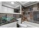 Bathroom with glass vessel sink, stone tile shower, and updated fixtures at 4417 Saint Andrews Cir, Las Vegas, NV 89107