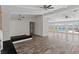 An open-concept living space with stylish wood flooring, bright windows, and doors to the pool area at 4417 Saint Andrews Cir, Las Vegas, NV 89107