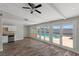 Bright living space featuring a pool view, wood floors, and a partial kitchen view at 4417 Saint Andrews Cir, Las Vegas, NV 89107