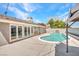 Backyard pool area with lounge area outside of the house at 4417 Saint Andrews Cir, Las Vegas, NV 89107