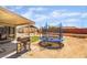 Wide backyard featuring a trampoline, grill, and block wall at 4691 Sun Valley Cir, Las Vegas, NV 89122