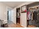 A large bedroom closet with wood-look laminate flooring and open shelving at 4691 Sun Valley Cir, Las Vegas, NV 89122
