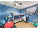 Cozy bedroom with a bunk bed, desk, and vibrant blue walls at 4691 Sun Valley Cir, Las Vegas, NV 89122