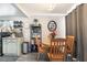 Cozy dining area featuring a round wooden table, chairs, decorative shelves, and soft, natural lighting at 4691 Sun Valley Cir, Las Vegas, NV 89122