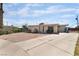 Single-story home with a gravel front yard, gated entrance, and a long driveway leading to the side of the property at 4691 Sun Valley Cir, Las Vegas, NV 89122