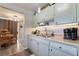 A kitchen featuring pale blue cabinets and wood-look laminate flooring leading to dining area at 4691 Sun Valley Cir, Las Vegas, NV 89122
