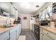 Kitchen with pale blue cabinets and wood-look laminate flooring and window views at 4691 Sun Valley Cir, Las Vegas, NV 89122