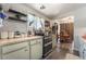 A kitchen featuring pale blue cabinets, wood-look laminate flooring, and modern shelving at 4691 Sun Valley Cir, Las Vegas, NV 89122
