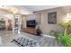 Cozy living area featuring wood-look floors, a sleek entertainment center, and a glimpse of the dining space at 4691 Sun Valley Cir, Las Vegas, NV 89122