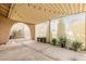 Covered back patio with pavers, decorative lights, mature desert plants, and a serene outdoor ambiance at 4998 Rappahanock St, Las Vegas, NV 89122