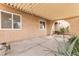 Covered back patio with pavers, mature desert plants, and a rose bush at 4998 Rappahanock St, Las Vegas, NV 89122