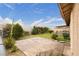 Spacious backyard features a patio, lawn, shrubs, and concrete block fence offering outdoor living and privacy at 4998 Rappahanock St, Las Vegas, NV 89122