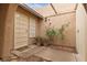Charming outdoor courtyard featuring desert landscaping, security gate, and covered entrance at 4998 Rappahanock St, Las Vegas, NV 89122