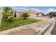 Well-maintained home with manicured lawn, mature shrubs, and a two-car garage with large driveway at 4998 Rappahanock St, Las Vegas, NV 89122