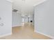 Open-concept living area with wood-look flooring and light neutral paint at 4998 Rappahanock St, Las Vegas, NV 89122
