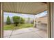 Covered patio with block wall, lush green lawn and mature landscaping at 4998 Rappahanock St, Las Vegas, NV 89122