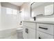 Modern bathroom with large vanity, quartz countertop, sleek fixtures, and white tile at 508 Van Dornum Ave, Henderson, NV 89011
