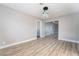 Spacious bedroom with modern lighting fixture, neutral paint, and seamless transition to hallway at 508 Van Dornum Ave, Henderson, NV 89011