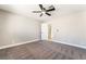 Comfortable bedroom with ceiling fan and carpeting offers a view of the hallway and kitchen at 508 Van Dornum Ave, Henderson, NV 89011