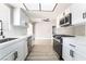Updated kitchen with stainless steel appliances, white cabinets, and bright, natural light at 508 Van Dornum Ave, Henderson, NV 89011