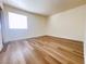 Bright bedroom showcasing wood-look flooring, neutral paint, and a window at 5321 River Glen Dr # 232, Las Vegas, NV 89103