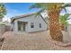Side view of the backyard and covered patio with desert landscaping at 5820 Royal Castle Ln, Las Vegas, NV 89130