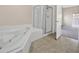 A bathroom featuring tile floors, shower and soaking tub at 5820 Royal Castle Ln, Las Vegas, NV 89130