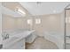 A spacious bathroom featuring double sinks, jacuzzi tub and walk in shower at 5820 Royal Castle Ln, Las Vegas, NV 89130