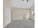 A neutral toned bedroom featuring vaulted ceiling, carpet and ensuite bathroom at 5820 Royal Castle Ln, Las Vegas, NV 89130