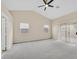 Spacious bedroom with neutral carpet, ceiling fan, and natural light at 5820 Royal Castle Ln, Las Vegas, NV 89130