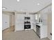 Updated kitchen featuring stainless steel appliances, white cabinets and tile flooring at 5820 Royal Castle Ln, Las Vegas, NV 89130