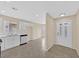 Spacious kitchen featuring stainless steel appliances and tile flooring with a view to the front door at 5820 Royal Castle Ln, Las Vegas, NV 89130