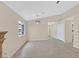 Open living room with fireplace, ceiling fan, tile floors and lots of natural light at 5820 Royal Castle Ln, Las Vegas, NV 89130