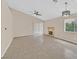 Spacious living room with fireplace, ceiling fan and sliding glass doors at 5820 Royal Castle Ln, Las Vegas, NV 89130