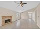 Large living room with fireplace, tile flooring, ceiling fan and lots of natural light at 5820 Royal Castle Ln, Las Vegas, NV 89130