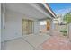 Covered patio with sliding glass door leads to the gravel-filled backyard at 5820 Royal Castle Ln, Las Vegas, NV 89130