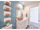Well-appointed bathroom with modern fixtures, decorative towel rack and a calming blue accent wall at 6109 Aster Garden St # 159, North Las Vegas, NV 89081
