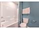 Clean bathroom featuring a shower-tub combo and blue accent wall at 6109 Aster Garden St # 159, North Las Vegas, NV 89081