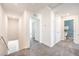 Bright hallway with neutral carpet, access to bedrooms and bathrooms and a staircase at 6109 Aster Garden St # 159, North Las Vegas, NV 89081