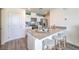 Kitchen with light countertops, white cabinets, seating at the counter and wood laminate flooring at 6109 Aster Garden St # 159, North Las Vegas, NV 89081