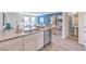 Open kitchen with stainless appliances, granite countertops, an island and adjacent dining and living areas at 6109 Aster Garden St # 159, North Las Vegas, NV 89081