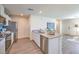 Open kitchen with stainless steel appliances, a peninsula with a sink, and wood look laminate flooring at 6109 Aster Garden St # 159, North Las Vegas, NV 89081